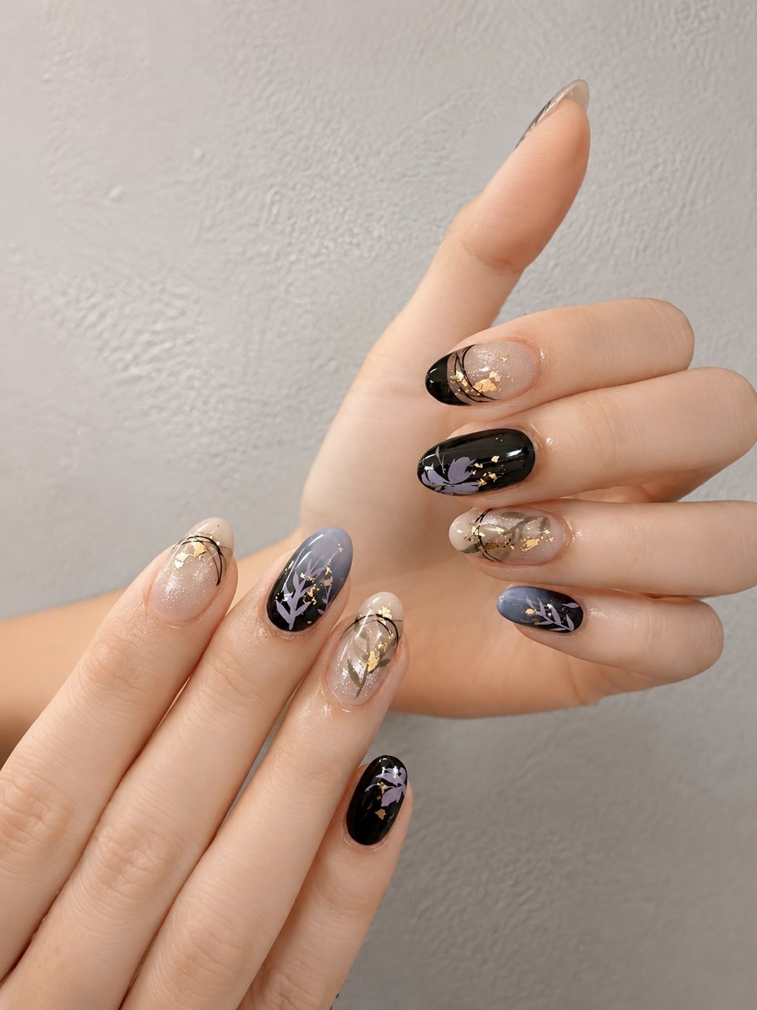 Black floral nail art on natural tips