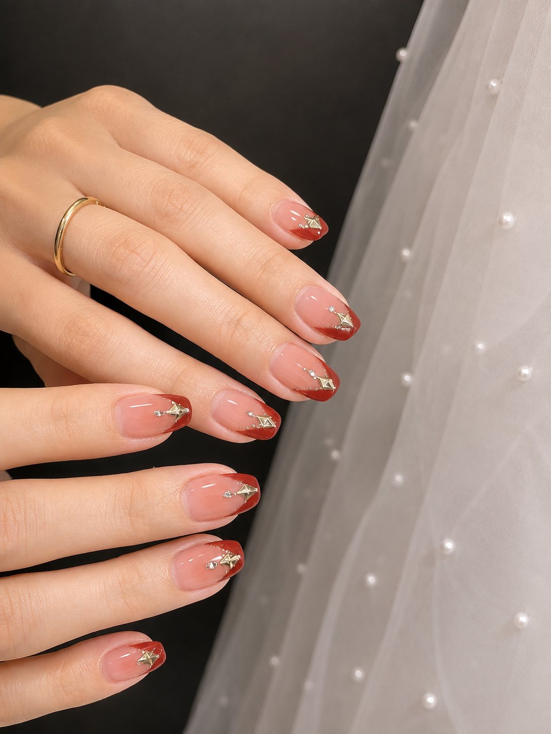 Red French tips with gold accents